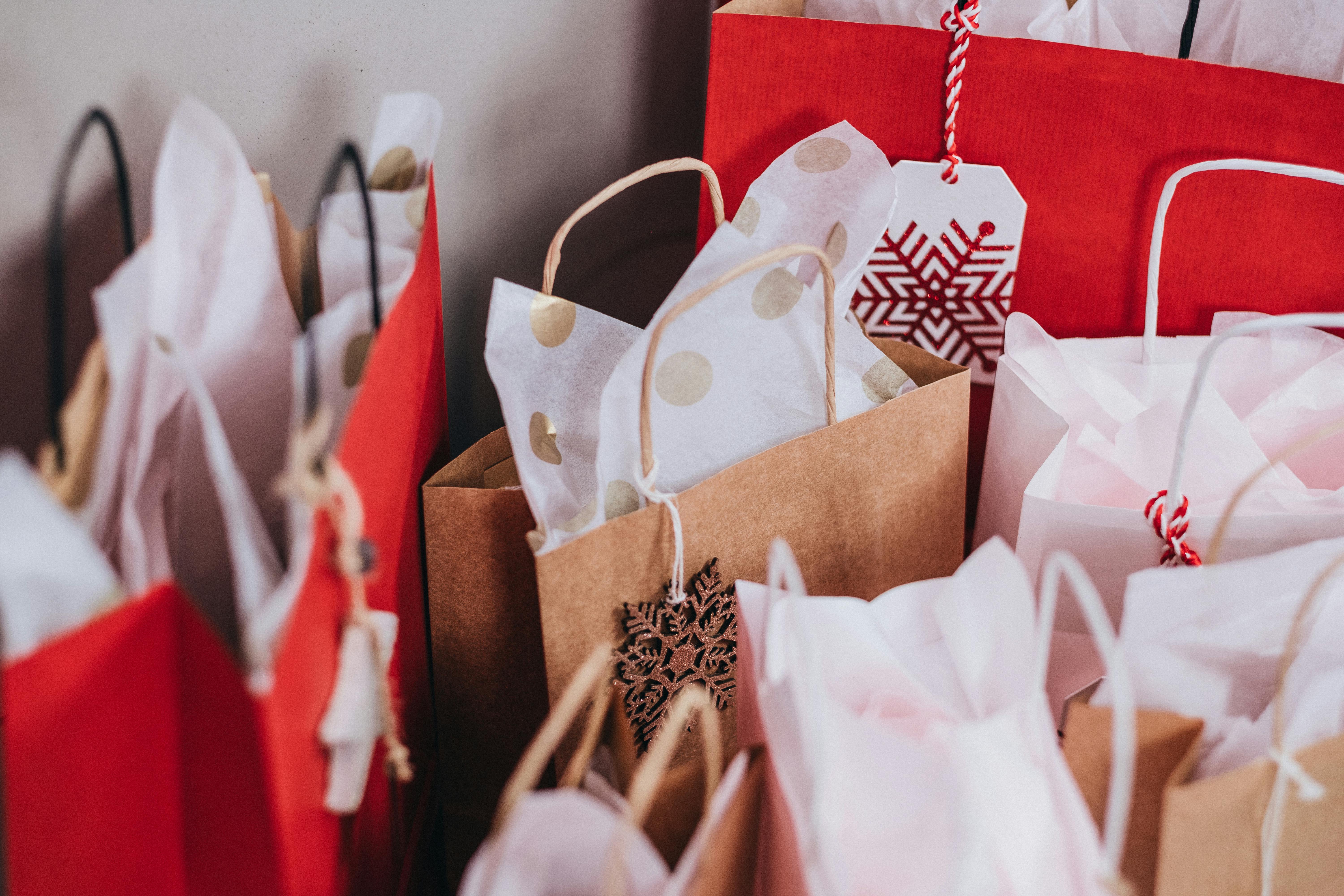 Photo of red, white, and brown holiday shopping bags